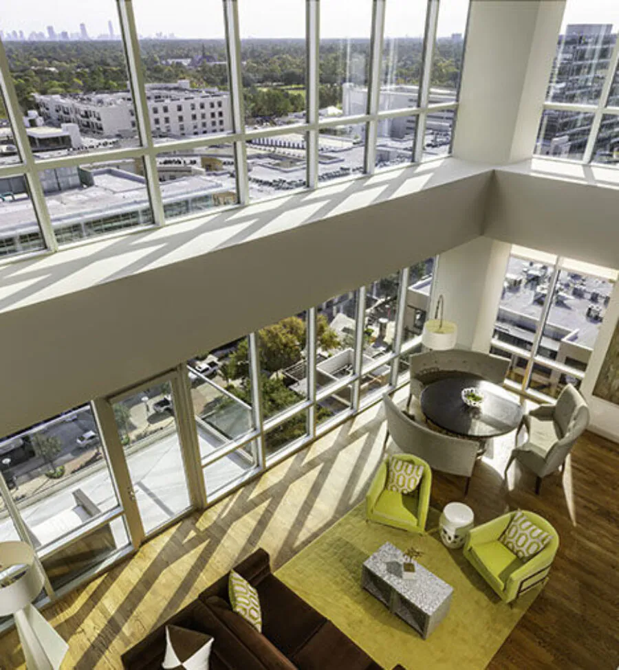 Living room with tall windows and modern furniture.
